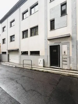 an empty street in front of a white building at C Center Apartment in Funchal