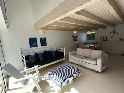 a living room with a couch and a table at Aljezur Bordeira Houses 3 bedrooms 2 bathrooms with Condo Pool in Bordeira