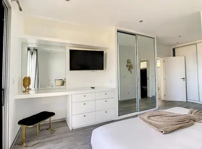 a white bedroom with a television and a bed at New Villa Piece of Heaven by Your Madeira Rentals in Estreito da Calheta