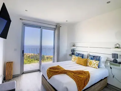 a bedroom with a large bed with a large window at New Villa Piece of Heaven by Your Madeira Rentals in Estreito da Calheta