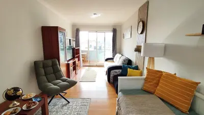 a living room with a couch and a chair at MCStylo-Vista Oceano in Caniço