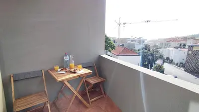 a small table on a balcony with a view at MCStylo-Vista Oceano in Caniço