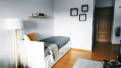 a bedroom with a bed and a lamp in it at MCStylo-Vista Oceano in Caniço