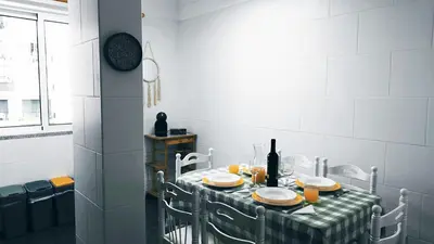 a dining room table with a green and white checkered table cloth at MCStylo-Vista Oceano in Caniço