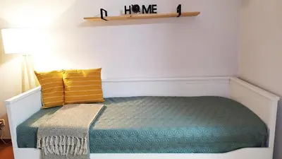 a bedroom with a bed with a home sign on the wall at MCStylo-Vista Oceano in Caniço