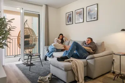 two people sitting on a couch in a living room at Carmo - Moon in Funchal