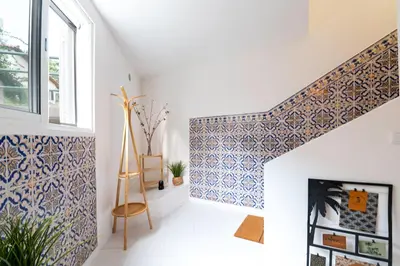a hallway with blue and white tiles on the wall at GREEN OASIS FUNCHAL HOUSE WITH 2 PRIVATE APARTMENTS and TERRACE in Funchal