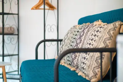 a bedroom with a bed with a pillow on it at GREEN OASIS FUNCHAL HOUSE WITH 2 PRIVATE APARTMENTS and TERRACE in Funchal