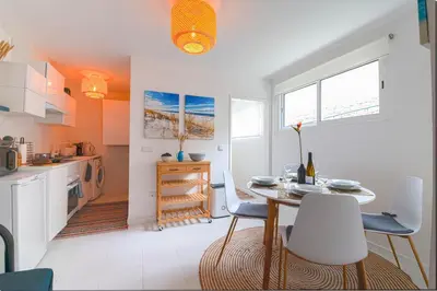 a kitchen and dining room with a table and chairs at GREEN OASIS FUNCHAL HOUSE WITH 2 PRIVATE APARTMENTS and TERRACE in Funchal