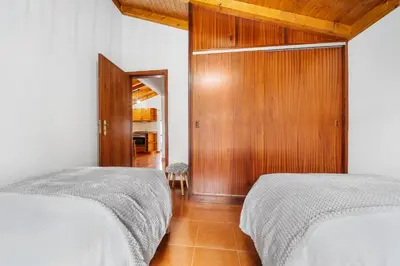 a bedroom with a bed with two pillows on it at Casa Katy by Atlântica in Calheta