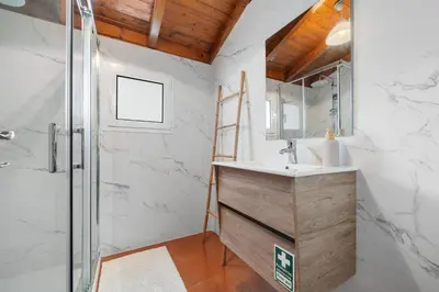 a bathroom with a sink and a shower at Casa Katy by Atlântica in Calheta