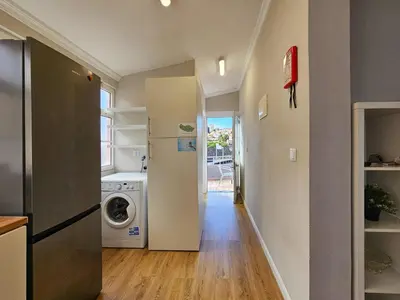 a kitchen with a refrigerator and a washing machine at Sunny House Funchal in Funchal
