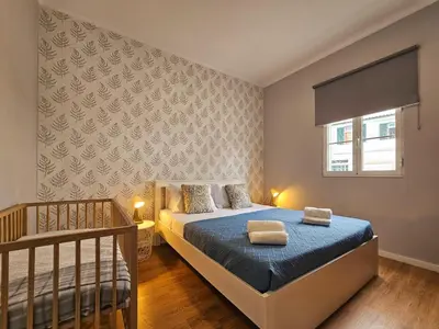 a bedroom with a bed and a crib at Sunny House Funchal in Funchal