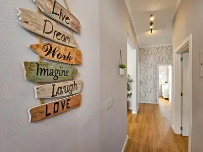 a hallway with directional signs on a wall at Sunny House Funchal in Funchal