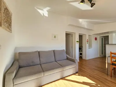 a living room with a couch and a table at Sunny Terrace Funchal in Funchal