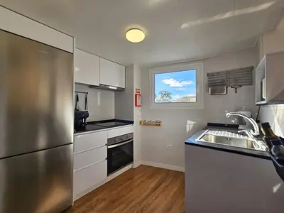 a kitchen with a stainless steel refrigerator and a sink at Sunny Terrace Funchal in Funchal