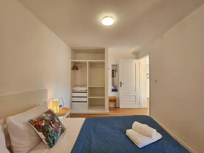 a bedroom with a bed and a room with a closet at Sunny Terrace Funchal in Funchal