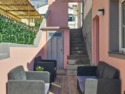 a patio with two chairs and a door at Sunny Terrace Funchal in Funchal