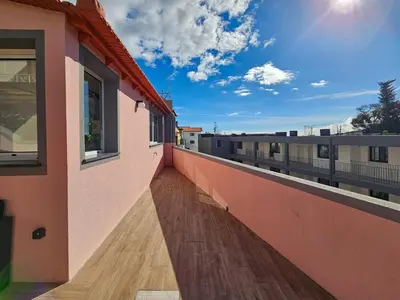 a balcony of a building with a wooden floor at Sunny Terrace Funchal in Funchal