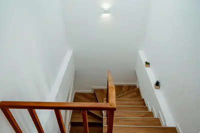 a stairway with a wooden bench and a stair case at Villa Arrifes Porto Santo in Porto Santo