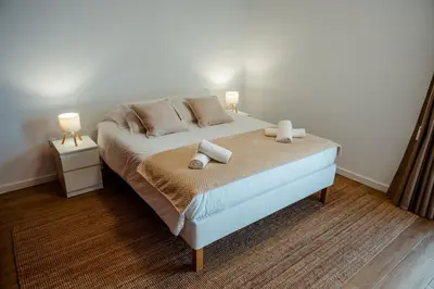 a bedroom with a bed with two candles on it at Villa Arrifes Porto Santo in Porto Santo