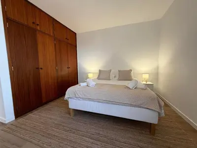 a bedroom with a large bed with two lamps on it at Villa Arrifes Porto Santo in Porto Santo