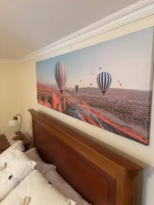 a bedroom with a picture of hot air balloons at Sea & Mountain View Home in Machico in Machico