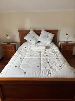 a large bed with white sheets and pillows at Sea & Mountain View Home in Machico in Machico
