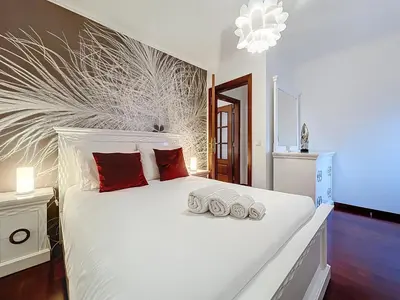 a bedroom with a white bed with three pillows at Villa Paixao by Atlantic Holiday in Machico