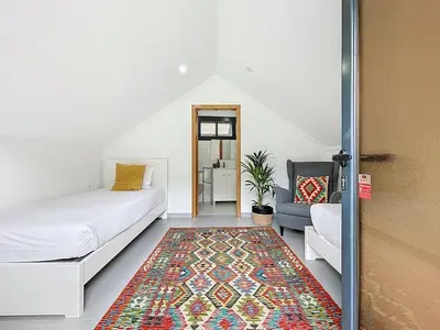 a living room with a bed and a rug at Villa Paixao by Atlantic Holiday in Machico