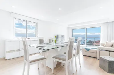 a white dining room with a table and chairs at Horizonte Completo II by Atlantic Holiday in Câmara de Lobos