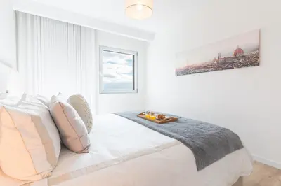 a white bedroom with a large white bed with pillows at Horizonte Completo II by Atlantic Holiday in Câmara de Lobos