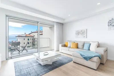 a living room with a couch and a large window at Horizonte Completo II by Atlantic Holiday in Câmara de Lobos