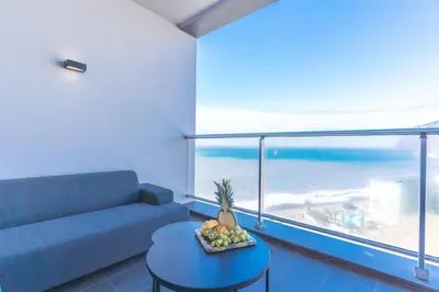 a dining room with a table and a view of the ocean at Pearl View by Atlantic Holiday in Funchal