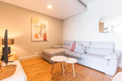 a living room with a white couch and a table at Pearl View by Atlantic Holiday in Funchal