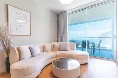 a living room with a table and chairs and a couch at Pearl View by Atlantic Holiday in Funchal
