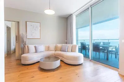 a living room with a table and a couch at Pearl View by Atlantic Holiday in Funchal