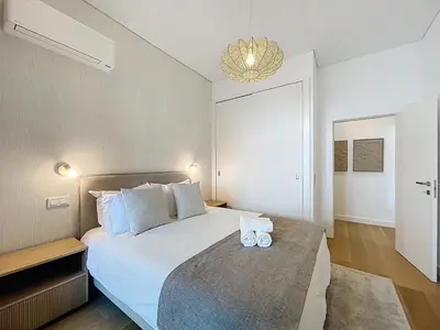 a bedroom with a large bed with two candles on it at Ocean Refuge by Atlantic Holiday in Funchal