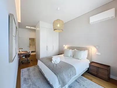 a bedroom with a large white bed and a table at Ocean Refuge by Atlantic Holiday in Funchal