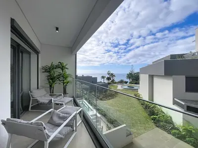 a balcony with chairs and a view of the ocean at Ocean Refuge by Atlantic Holiday in Funchal