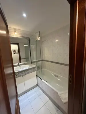 a bathroom with a tub and a sink and a shower at Refugio do Ferreirinha in Caniço