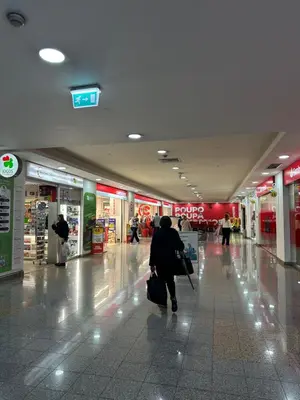 a person is walking through a shopping mall at Refugio do Ferreirinha in Caniço