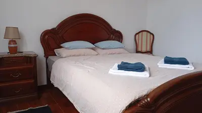 a bedroom with a bed with two towels on it at Yellow Owl II Bedroom I in Campanário