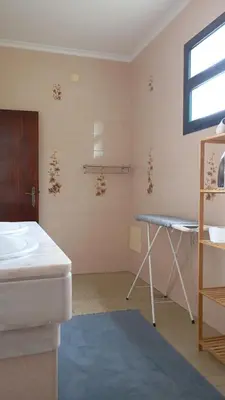 a room with a sink and a table and a window at Yellow Owl II Bedroom I in Campanário