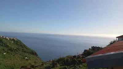 a view of the ocean from a hill at Yellow Owl II Bedroom I in Campanário