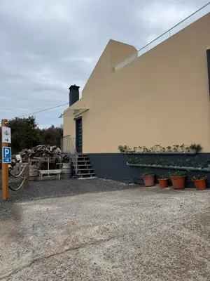 a sign for a pathine dos sis restaurant with the ocean at Palheiro dos 3 A`s in Achadas da Cruz