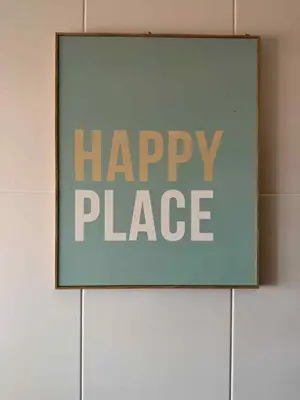 a sign with the words happy place on a wall at A&CSuite in Caniço