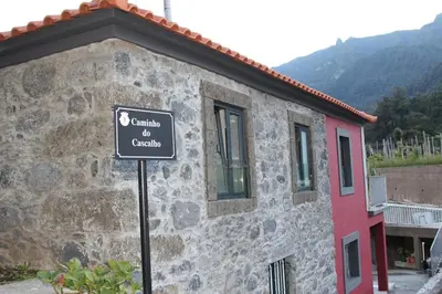 a building with a sign in front of it at A Casa da Carolina in São Vicente