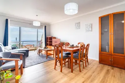 a living room with a table and chairs and a dining room at GuestReady - Ocean breeze retreat in Santa Cruz