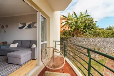 a balcony with a couch and a chair at GuestReady - Ocean breeze retreat in Santa Cruz